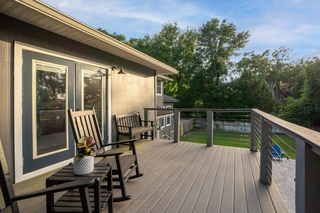 wooden deck with a lawn