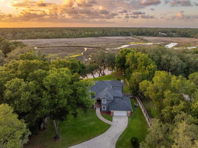 aerial view at dusk with a water view