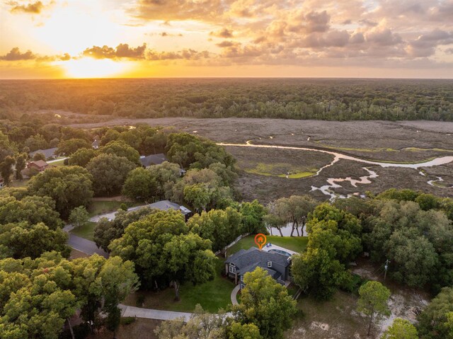 aerial view at dusk featuring a water view