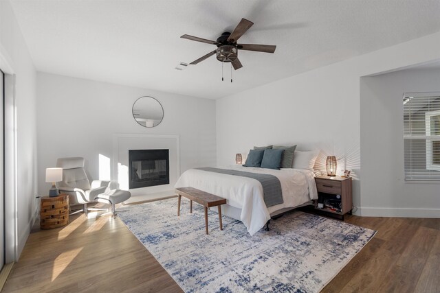 bedroom with ceiling fan and dark wood-type flooring