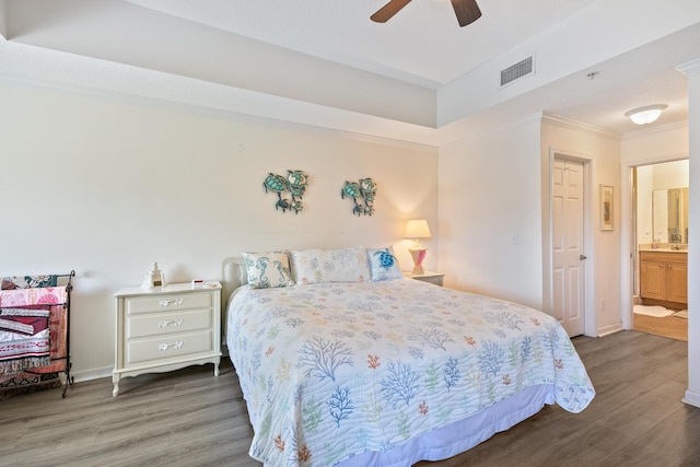 bedroom with hardwood / wood-style floors, connected bathroom, ceiling fan, and crown molding