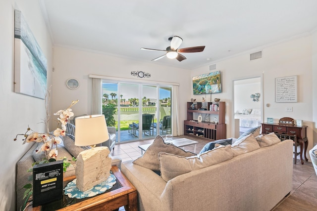 tiled living room featuring crown molding and ceiling fan