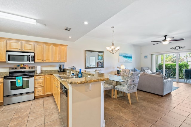 kitchen with ceiling fan with notable chandelier, sink, light brown cabinetry, appliances with stainless steel finishes, and kitchen peninsula