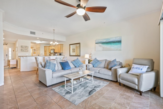 living room featuring ceiling fan with notable chandelier