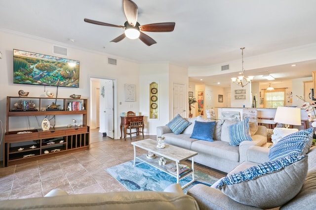 living room featuring ceiling fan with notable chandelier and ornamental molding