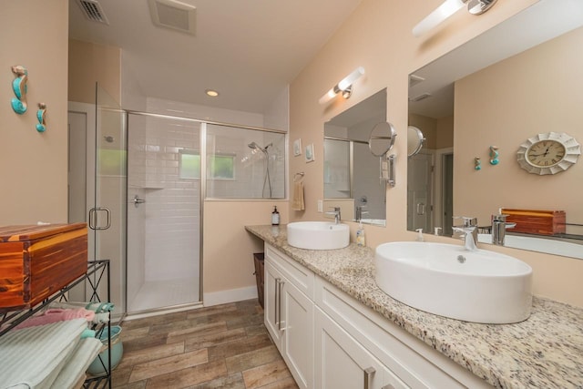 bathroom with vanity and an enclosed shower