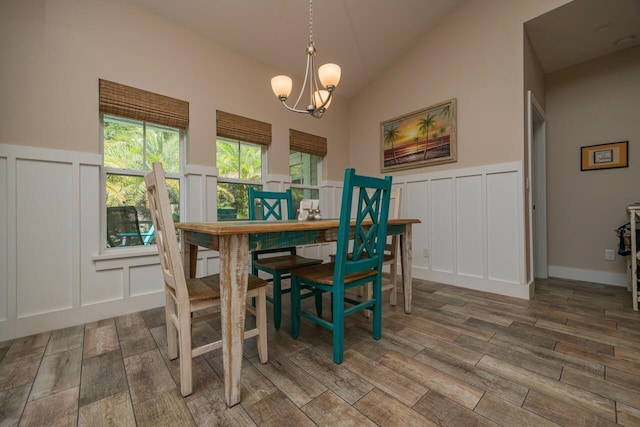 dining room with an inviting chandelier and vaulted ceiling