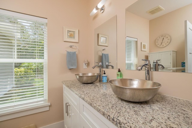 bathroom featuring a wealth of natural light and vanity