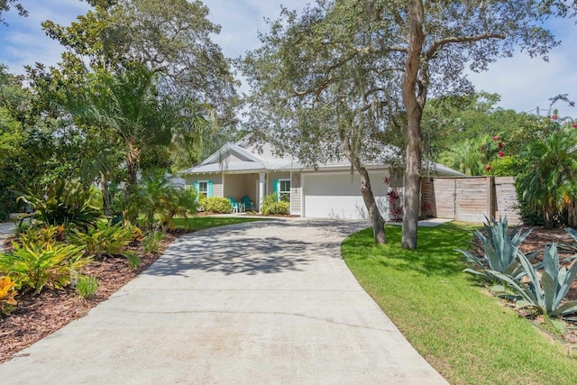 single story home featuring a front lawn and a garage