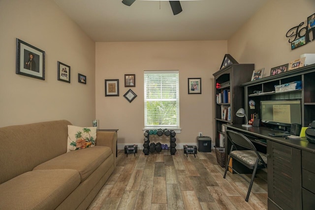 office with light hardwood / wood-style floors and ceiling fan