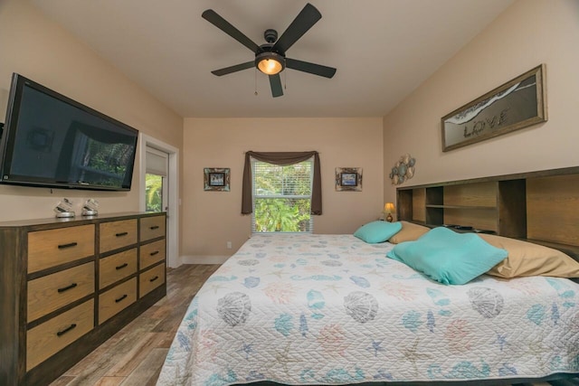 bedroom with ceiling fan and hardwood / wood-style floors