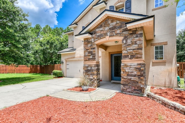 104 Claremont Ct, Elkton, FL 32033 - property entrance featuring stone siding, stucco siding, and driveway