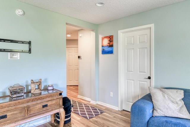 104 Claremont Ct, Elkton, FL 32033 - sitting room featuring light wood-style floors and a textured ceiling