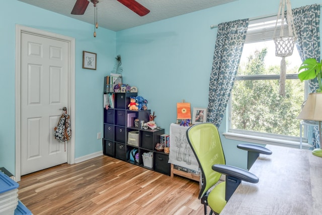 104 Claremont Ct, Elkton, FL 32033 - home office featuring wood finished floors, ceiling fan, healthy amount of natural light, and a textured ceiling