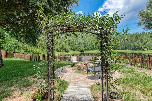 104 Claremont Ct, Elkton, FL 32033 - fenced backyard with a fire pit, a patio, and a water view