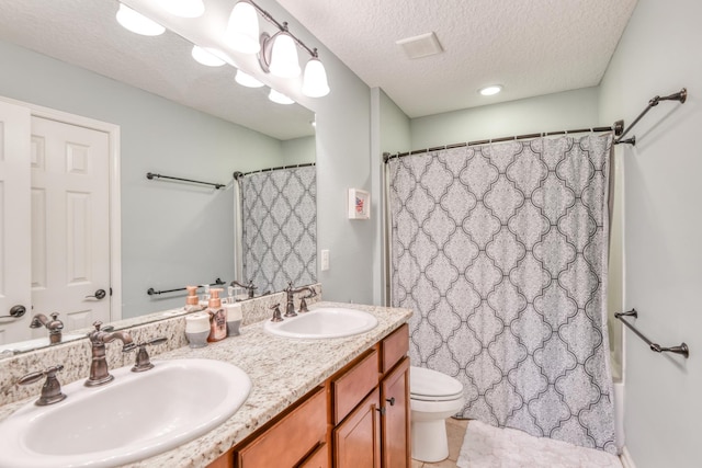 104 Claremont Ct, Elkton, FL 32033 - full bath featuring double vanity, a textured ceiling, and tile patterned floors