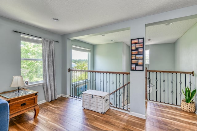104 Claremont Ct, Elkton, FL 32033 - living area featuring an upstairs landing, wood finished floors, and a textured ceiling