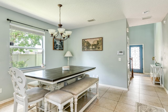 104 Claremont Ct, Elkton, FL 32033 - dining room featuring a chandelier, a textured ceiling, and light tile patterned floors