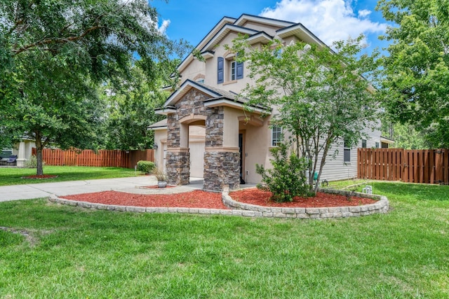 104 Claremont Ct, Elkton, FL 32033 - view of front of home featuring stone siding, stucco siding, and driveway