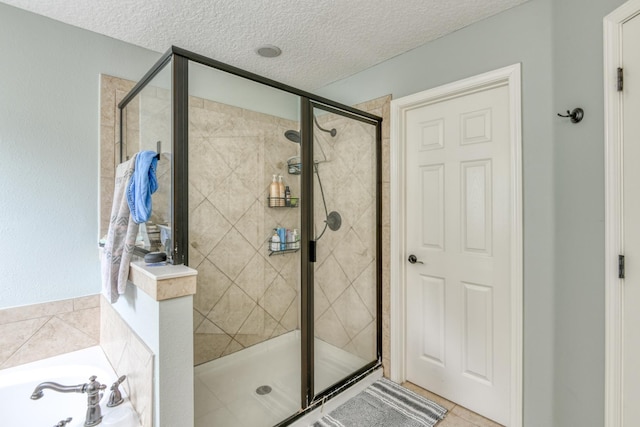 104 Claremont Ct, Elkton, FL 32033 - full bathroom with a stall shower, a garden tub, a textured ceiling, and tile patterned flooring