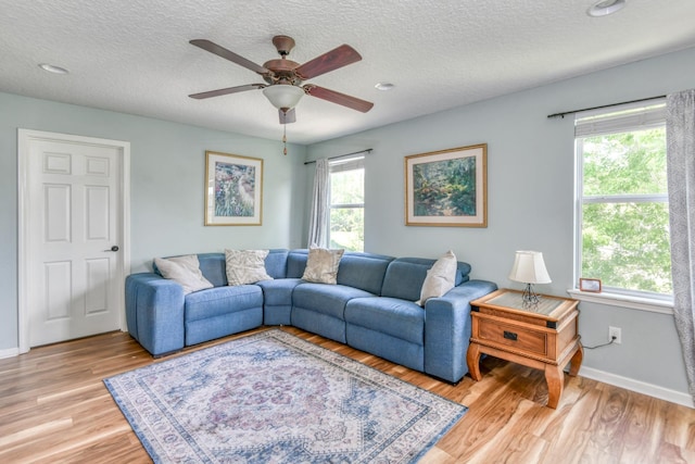 104 Claremont Ct, Elkton, FL 32033 - living area featuring healthy amount of natural light, ceiling fan, light wood-type flooring, and a textured ceiling