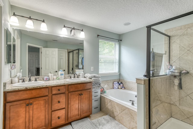 104 Claremont Ct, Elkton, FL 32033 - bathroom with a stall shower, a bath, double vanity, a textured ceiling, and tile patterned floors