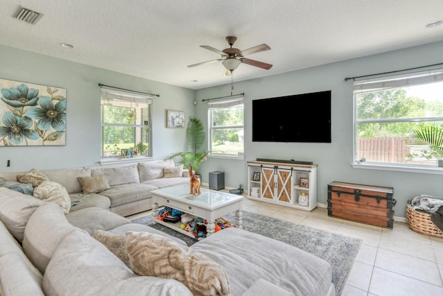 104 Claremont Ct, Elkton, FL 32033 - living area featuring tile patterned floors, ceiling fan, and a textured ceiling