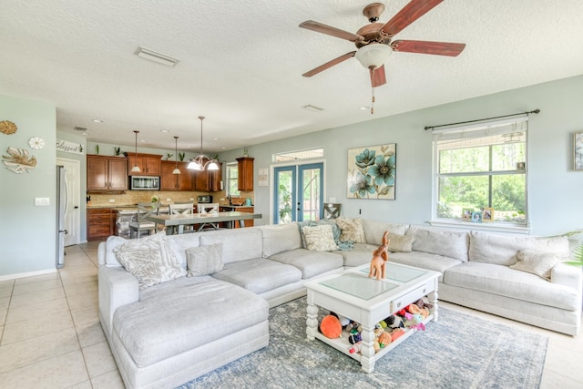 104 Claremont Ct, Elkton, FL 32033 - living area with healthy amount of natural light, light tile patterned floors, a textured ceiling, and ceiling fan