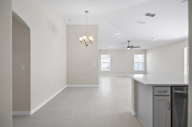 kitchen featuring light tile patterned floors, ceiling fan, gray cabinetry, hanging light fixtures, and vaulted ceiling