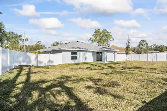 back of house featuring a lawn