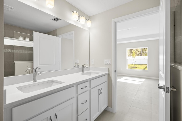 bathroom featuring tile patterned floors, vanity, and a shower