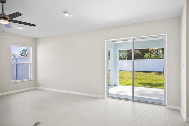 empty room featuring light tile patterned floors and ceiling fan