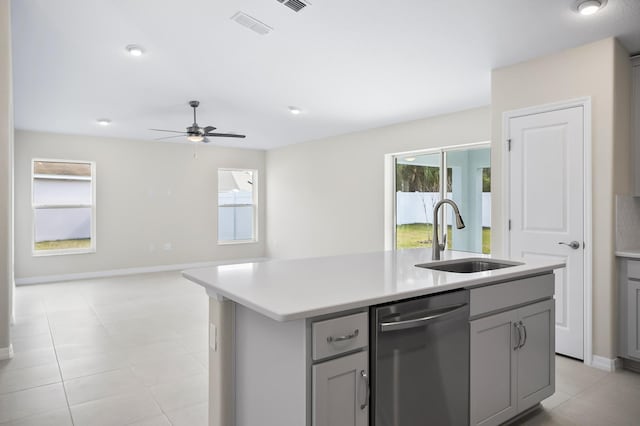 kitchen with a kitchen island with sink, sink, gray cabinets, and dishwasher