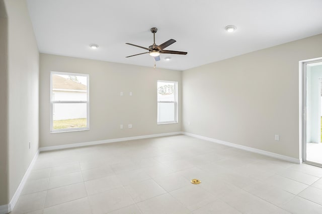 spare room featuring a healthy amount of sunlight and ceiling fan