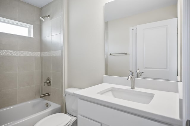 full bathroom with vanity, toilet, and tiled shower / bath