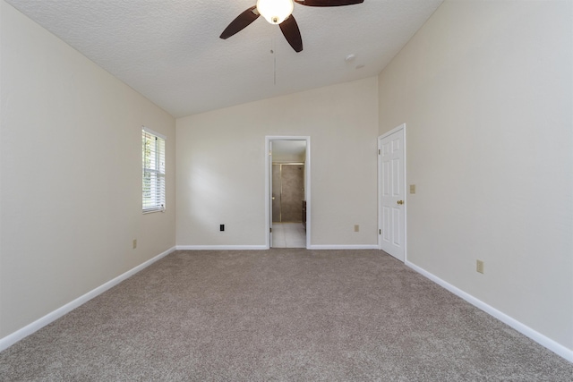 spare room with a textured ceiling, carpet floors, ceiling fan, and lofted ceiling