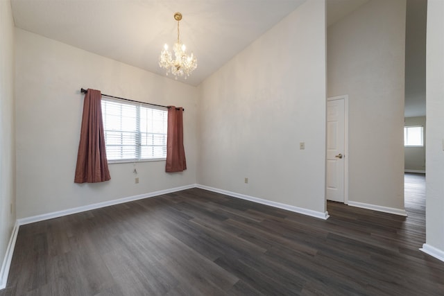 spare room with high vaulted ceiling, dark hardwood / wood-style floors, and a notable chandelier