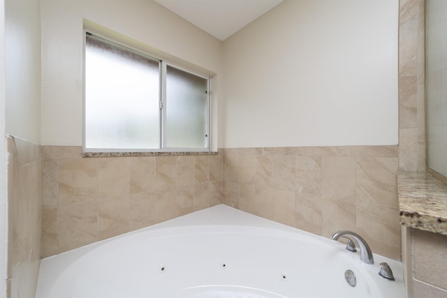 bathroom with plenty of natural light and tiled bath