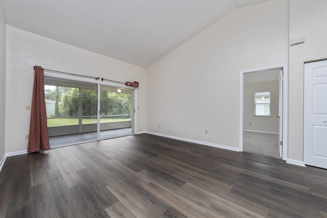 spare room with dark hardwood / wood-style flooring, high vaulted ceiling, and a textured ceiling