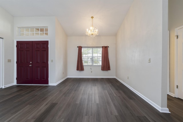 entrance foyer with dark wood-type flooring and an inviting chandelier