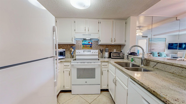 kitchen featuring white cabinetry, sink, ceiling fan, light stone countertops, and white appliances