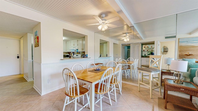 tiled dining room featuring ceiling fan