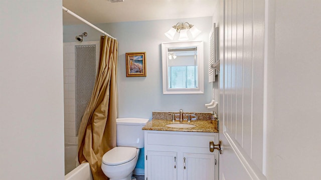 full bathroom with vanity, shower / tub combo, and toilet