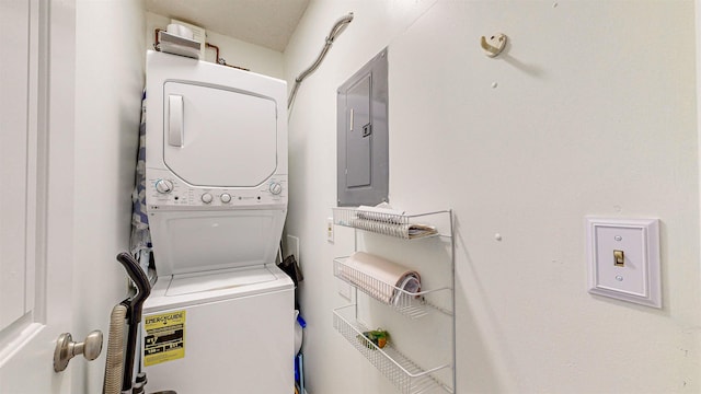 clothes washing area with electric panel and stacked washing maching and dryer