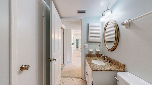 bathroom with tile patterned floors, vanity, and toilet