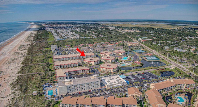 bird's eye view featuring a water view and a beach view