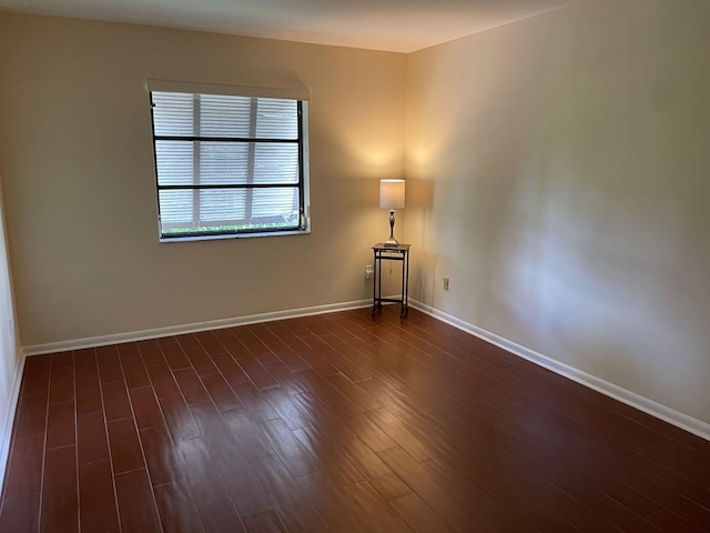 empty room with dark wood-type flooring