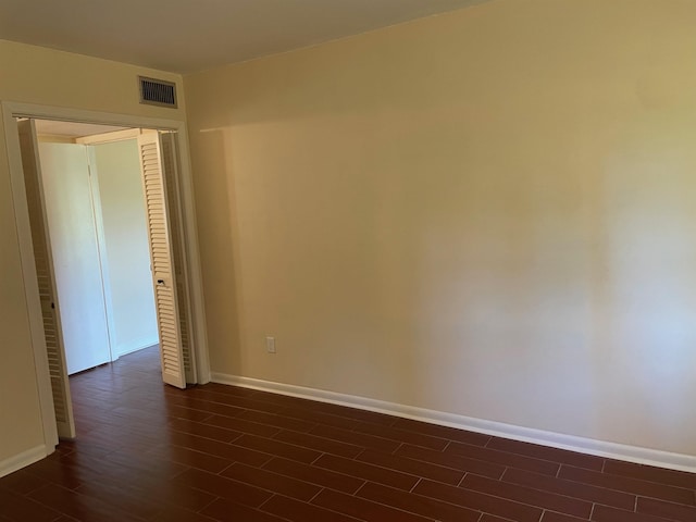 unfurnished room featuring dark hardwood / wood-style flooring