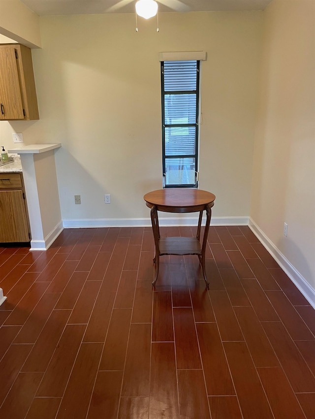 unfurnished dining area with dark hardwood / wood-style flooring and ceiling fan