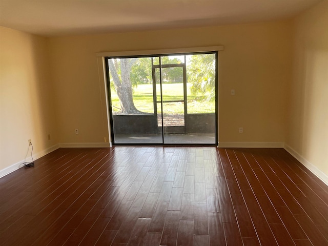 unfurnished room featuring dark wood-type flooring